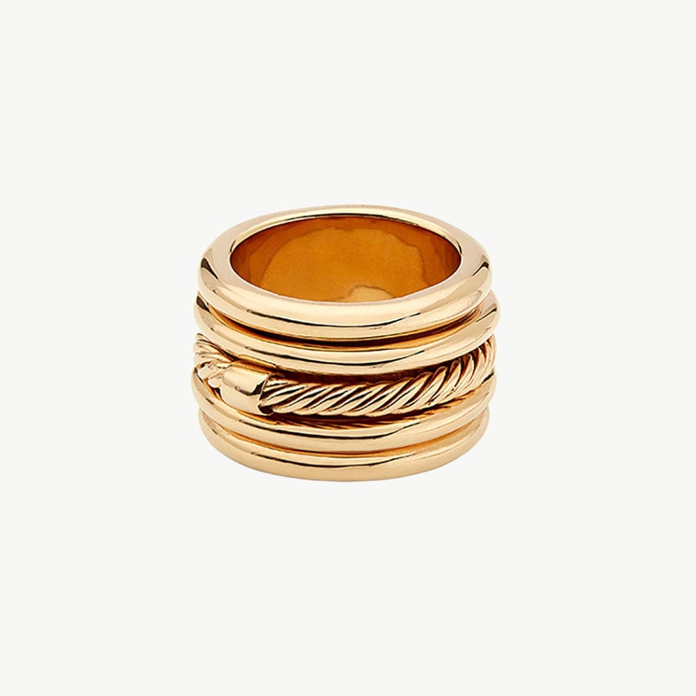 Gold spinner ring with layered moving bands photographed on a clean background