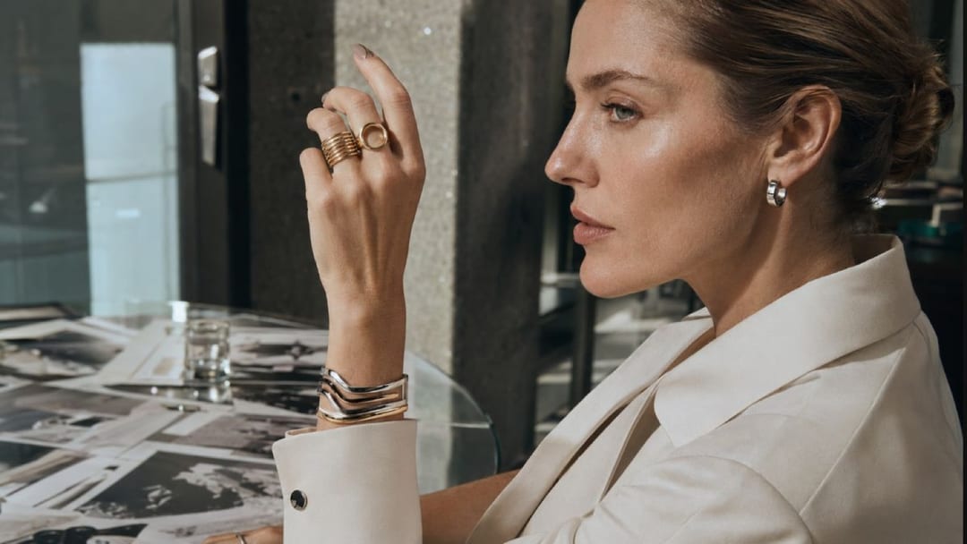 Office nails styled with sculptural office jewelry on a warm gray desk